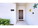 Close-up of the front door with floral decorations and address number 3083 at 3083 Tom Sawyer Dr, Kissimmee, FL 34746