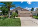 Inviting home exterior with a well-manicured lawn, a two-car garage, and neutral color tones at 3188 Verbena Ct, Deltona, FL 32725