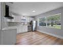 Bright and airy kitchen with sleek stainless steel appliances and a large window at 3474 Fairway Ln, Orlando, FL 32804