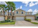Inviting townhome exterior featuring lush landscaping and a private garage entrance at 3530 Rodrick Cir, Orlando, FL 32824