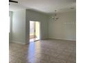 Open living room with tiled floors and sliding glass door to the patio at 3530 Rodrick Cir, Orlando, FL 32824