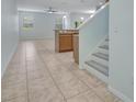 Open-concept living area with tile flooring and staircase at 3530 Rodrick Cir, Orlando, FL 32824