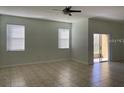 Spacious living room with tiled floors, ceiling fan, and natural light at 3530 Rodrick Cir, Orlando, FL 32824