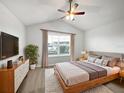 Cozy bedroom with a large window, neutral decor, ceiling fan, and a plush rug at 3737 Plainview Dr, Orlando, FL 32824