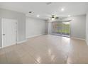 Spacious open-plan living room with tile flooring, recessed lighting, and access to the outdoor patio at 3737 Plainview Dr, Orlando, FL 32824