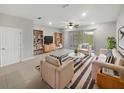 Bright living room featuring neutral-toned furniture, striped rug, and sliding glass doors to the outdoors at 3737 Plainview Dr, Orlando, FL 32824