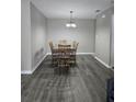 This dining room features wood floors and a chandelier lighting the space at 4936 Tangerine Ave # 4936, Winter Park, FL 32792