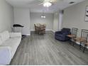 Spacious living room with hardwood floors and ample seating and dining area at 4936 Tangerine Ave # 4936, Winter Park, FL 32792