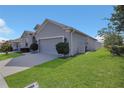 Well maintained home with green lawn and two car garage at 567 Pinecrest Loop, Davenport, FL 33837