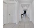 Bright hallway featuring tray ceiling, neutral walls, and tile flooring at 567 Pinecrest Loop, Davenport, FL 33837