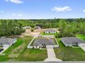 This aerial view showcases the property and its surroundings, including neighboring houses and green spaces at 606 Marion Oaks Blvd, Ocala, FL 34473