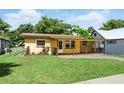 Inviting single-story home featuring a covered porch and a well-manicured front lawn at 606 Ohio Ave, St Cloud, FL 34769