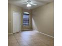 Neutral bedroom with tile flooring, a large window, and a closet at 6169 Metrowest Blvd # 102, Orlando, FL 32835