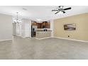 Spacious living room with tile floors, ceiling fan and open floor plan to the kitchen at 617 Joyful Blossom Pl, Longwood, FL 32750