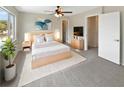 Bright bedroom with a large window, ceiling fan, stylish rug, and a modern bed frame at 721 Rock Creek Loop, Longwood, FL 32750