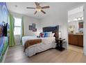 Bright bedroom with Super Mario mural wall and door that leads into the primary bathroom at 7739 Graben St, Kissimmee, FL 34747