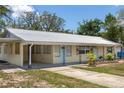 Beautiful home featuring a metal roof, pale yellow exterior and a long driveway at 88 E Charlotte Ave, Eustis, FL 32726
