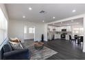 Open-concept living space with dark floors, white walls, stainless steel appliances, and recessed lighting at 88 E Charlotte Ave, Eustis, FL 32726