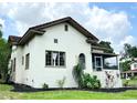 Elegant stucco home with manicured landscaping, showcasing its classic architectural design and charming curb appeal at 900 Carlton Ave, Lake Wales, FL 33853