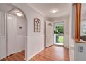 Welcoming foyer with hardwood floors, wainscotting and an open door offering natural light at 915 Oregon St, Orlando, FL 32803
