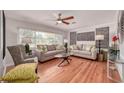 Bright living room featuring hardwood floors, stylish sofas, accent pillows, and large windows for natural light at 915 Oregon St, Orlando, FL 32803