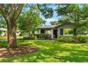Charming single-story home featuring a well-maintained lawn and a mature shade tree in a quiet neighborhood at 927 Boardman St, Orlando, FL 32804