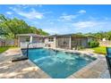 Backyard featuring a sparkling pool with a patio, complemented by a screened-in porch for outdoor enjoyment at 927 Boardman St, Orlando, FL 32804