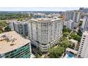 Beautiful exterior shot of a high-rise condominium building with balconies and lush landscaping at 100 S Eola Dr # 1406, Orlando, FL 32801