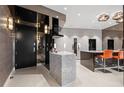 A gourmet kitchen featuring sleek cabinetry, a marble island, and stainless steel appliances at 100 S Eola Dr # 1406, Orlando, FL 32801
