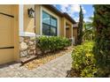 Close up of walkway, stone accents and manicured landscaping add elegance to the exterior at 10111 Tierra Bella Dr, Orlando, FL 32825
