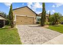 Charming home with a paved driveway, verdant lawn and mature trees providing a serene setting at 10111 Tierra Bella Dr, Orlando, FL 32825