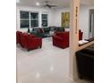 Spacious living room featuring plush seating, bright windows, and modern decor at 10148 Malpas Pt, Orlando, FL 32832