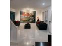 Bright living room with tile flooring, large art piece, and modern furniture at 10148 Malpas Pt, Orlando, FL 32832