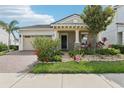 Charming home with a well-manicured lawn and flower beds enhancing the curb appeal at 10203 Henbury St, Orlando, FL 32832