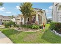 Well-maintained front yard showcasing lush greenery, colorful flowers and stone accents, enhancing curb appeal at 10203 Henbury St, Orlando, FL 32832