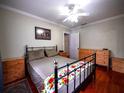 Cozy bedroom with hardwood floors, a ceiling fan, and natural light at 1102 S Oak Ave, Sanford, FL 32771