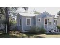 Quaint cottage-style house features a welcoming front porch and light blue siding at 1102 S Oak Ave, Sanford, FL 32771