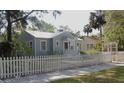 Charming cottage-style home with a white picket fence and well-maintained landscaping at 1102 S Oak Ave, Sanford, FL 32771