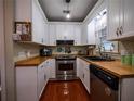 Efficient kitchen with white cabinetry, butcher block counters, and stainless steel appliances at 1102 S Oak Ave, Sanford, FL 32771