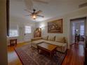 Comfortable living room with hardwood floors, a ceiling fan, and a large area rug at 1102 S Oak Ave, Sanford, FL 32771