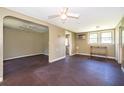 The living room has vintage floors, paneled walls, and a ceiling fan, with an open view to adjacent rooms at 1121 Votaw Rd, Apopka, FL 32703