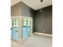 This dining room features sliding glass doors leading to an enclosed patio with modern lighting fixture at 11373 Darlington Dr, Orlando, FL 32837
