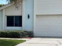 Close up view of the light blue exterior with the front of a white garage at 11373 Darlington Dr, Orlando, FL 32837