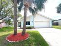 Inviting one-story home with a manicured lawn and lovely landscaping at 11373 Darlington Dr, Orlando, FL 32837