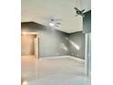 Spacious living room features sleek tile flooring, a modern ceiling fan, and sliding glass doors at 11373 Darlington Dr, Orlando, FL 32837