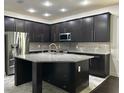 Modern kitchen featuring a large island, stainless steel appliances, and sleek cabinetry at 11464 Center Lake Dr, Windermere, FL 34786