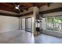 Bright and airy living room with wood beam ceiling, tile floors and large windows overlooking trees at 115 Tomoka Trl # 115, Longwood, FL 32779