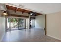 Bright living room featuring tile floors, exposed wood beams, and sliding glass doors to outside at 115 Tomoka Trl # 115, Longwood, FL 32779