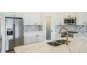 This newly remodeled kitchen includes stainless steel appliances and a center island at 117 Sanderling Dr, Haines City, FL 33844
