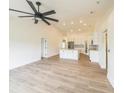Open-concept living room flows into a modern kitchen with an island and recessed lighting at 117 Sanderling Dr, Haines City, FL 33844